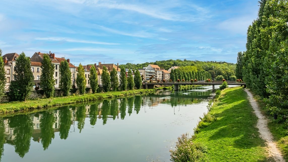 Ville et campus de Pigier Melun au loin. Un fleuve se trouve entre deux chemins.
