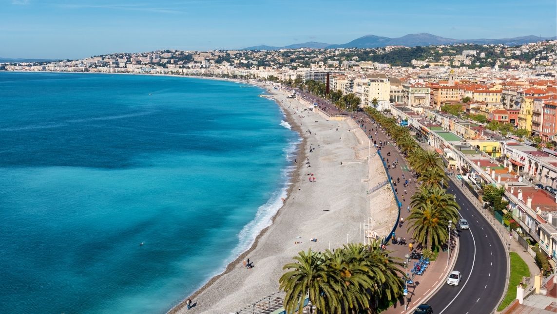 Vue de la mer et de la ville de Nice. A gauche, la mer turquoise et foncé. A droite, la place et la ville. 
