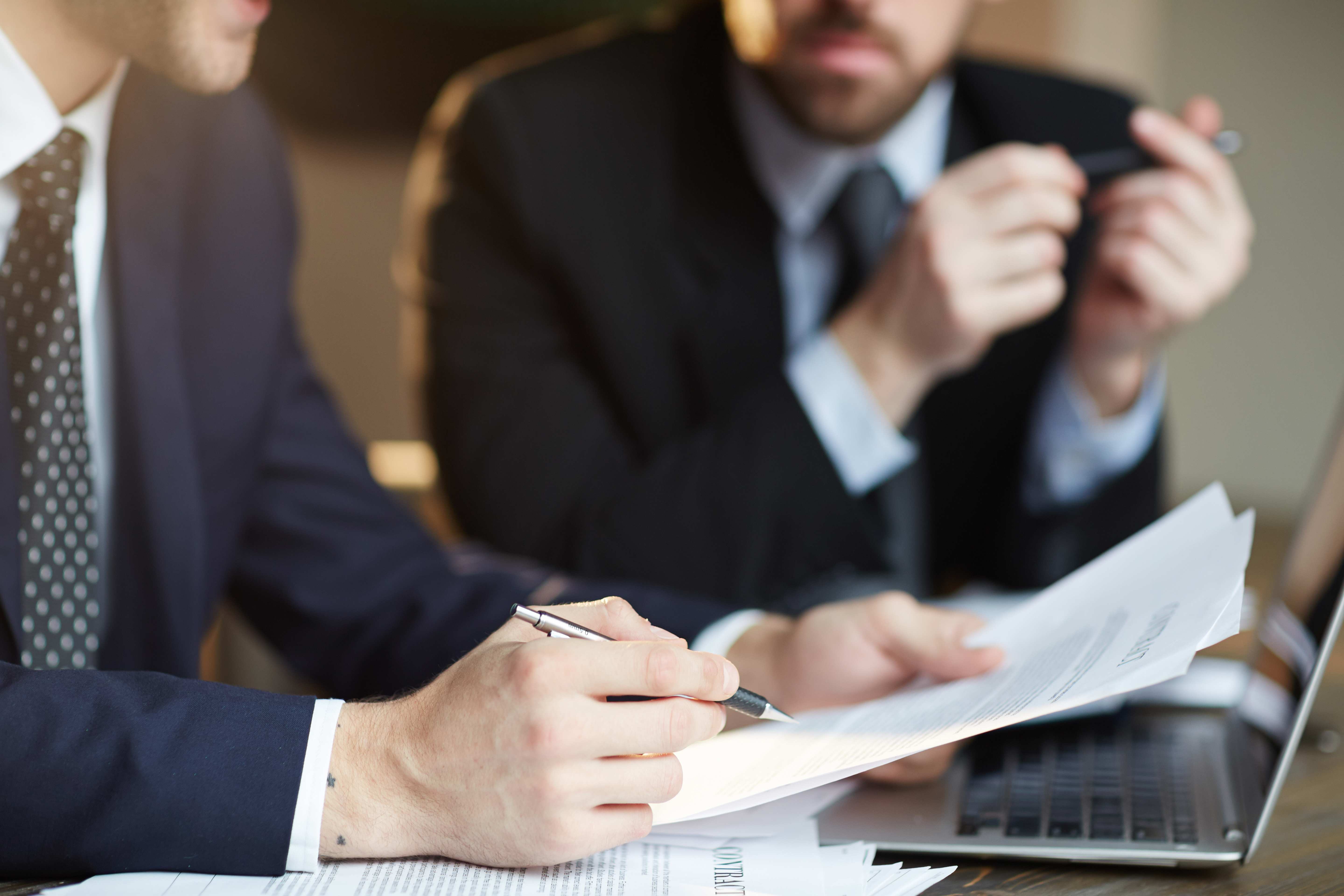 successful-business-partners-discussing-contract