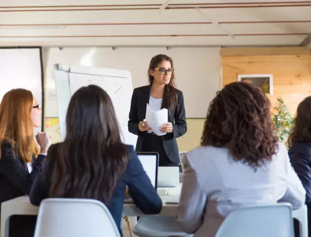 businesswomen-looking-speaker-with-papers