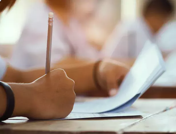 closeup-hand-student-holding-pencil-taking-exam-classroom-with-stress-education-test