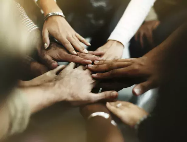 closeup-of-diverse-people-joining-their-hands
