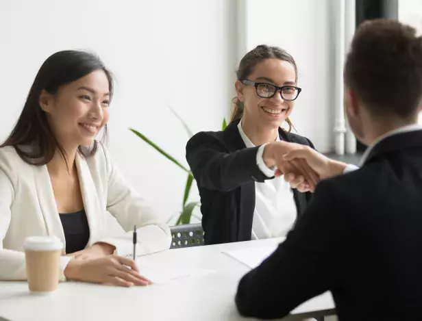 businessman-shaking-hand-female-coworker-company-meeting