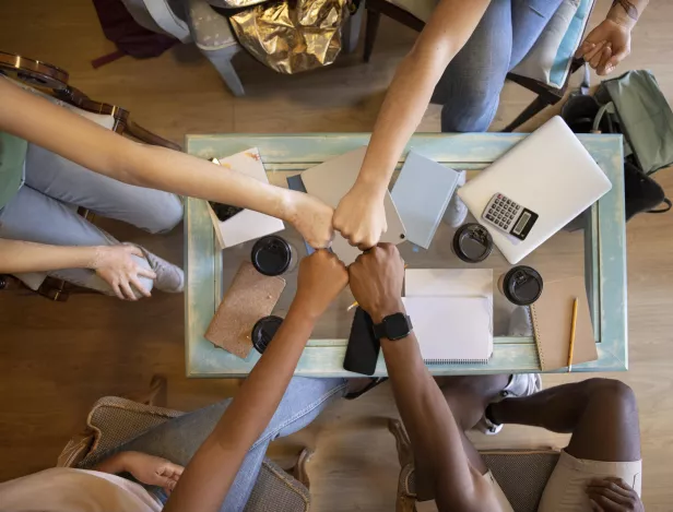 close-up-students-fist-bumping